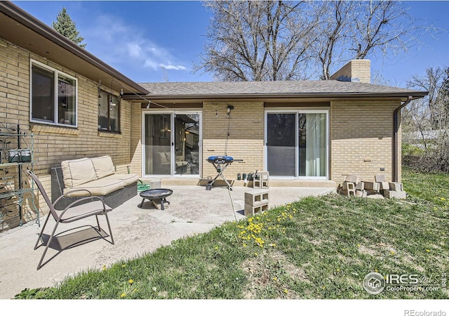 1036 Meadowbrook Dr, Fort Collins, CO 80521 - rear view of property featuring brick siding, a chimney, a patio area, a lawn, and a shingled roof