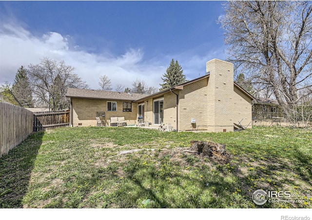 1036 Meadowbrook Dr, Fort Collins, CO 80521 - back of house with brick siding, a fenced backyard, a patio, and a chimney