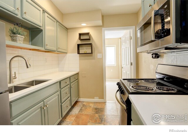 1620 Oak Ave, Boulder, CO 80304 - kitchen with appliances with stainless steel finishes, tasteful backsplash, open shelves, light countertops, and stone tile floors