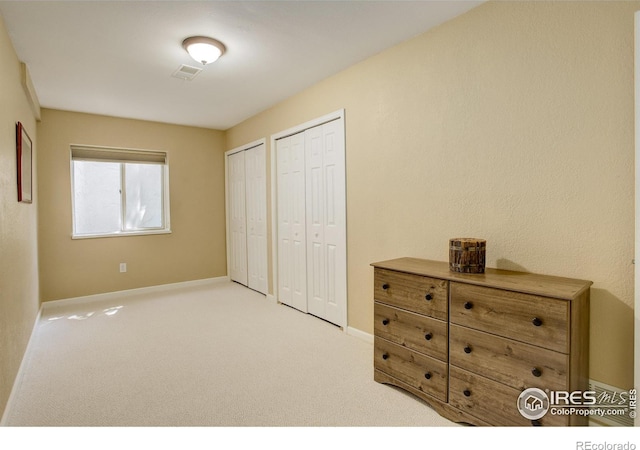 1620 Oak Ave, Boulder, CO 80304 - carpeted bedroom with multiple closets and baseboards