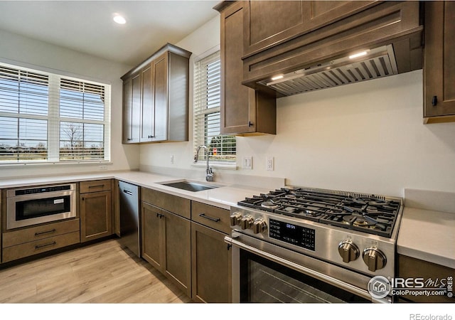3045 E Trilby Rd Unit B-10, Fort Collins, CO 80528 - kitchen with appliances with stainless steel finishes, custom exhaust hood, light wood-type flooring, healthy amount of natural light, and recessed lighting