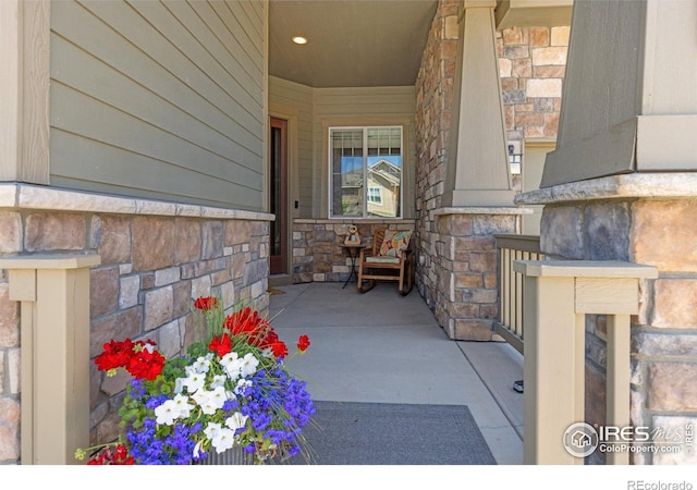 1963 Blue Yonder Way, Fort Collins, CO 80525 - doorway to property featuring stone siding and a porch