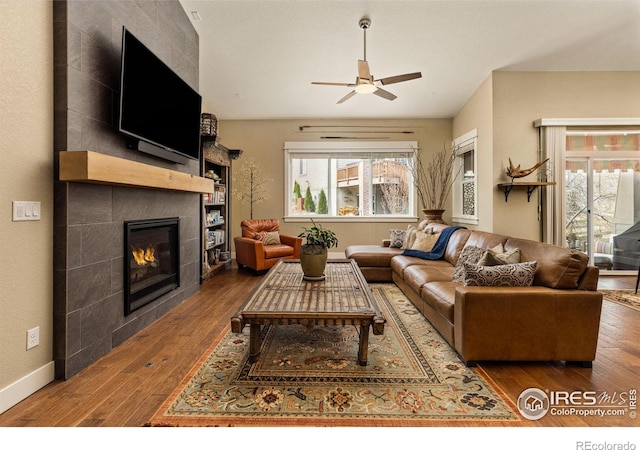 1963 Blue Yonder Way, Fort Collins, CO 80525 - living area with hardwood / wood-style floors, a ceiling fan, and a fireplace