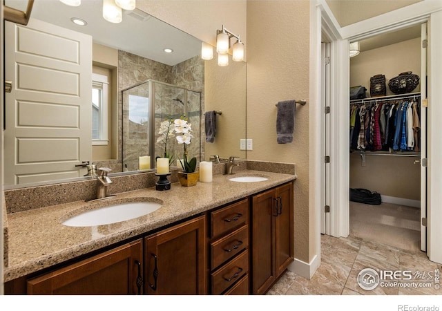 1963 Blue Yonder Way, Fort Collins, CO 80525 - bathroom featuring a stall shower, a spacious closet, double vanity, and a textured wall