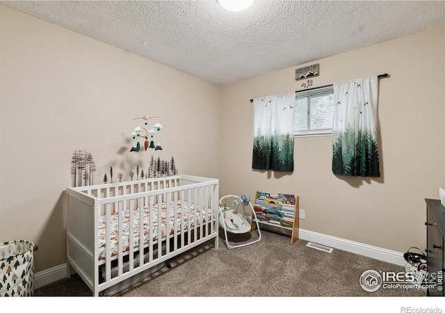 1607 Rushmore Dr, Colorado Springs, CO 80910 - bedroom with carpet, a textured ceiling, and a crib