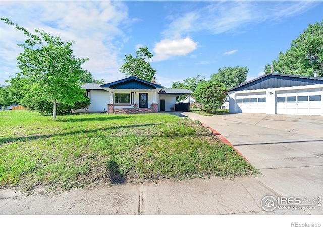 707 E Emma St, Lafayette, CO 80026 - single story home featuring a detached garage, a front yard, and a chimney