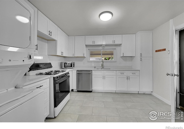 707 E Emma St, Lafayette, CO 80026 - kitchen with range with gas stovetop, stainless steel dishwasher, stacked washer and clothes dryer, light countertops, and light tile patterned floors