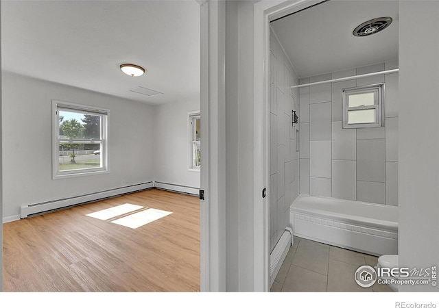 707 E Emma St, Lafayette, CO 80026 - full bath with a baseboard radiator, healthy amount of natural light, and shower / bathtub combination
