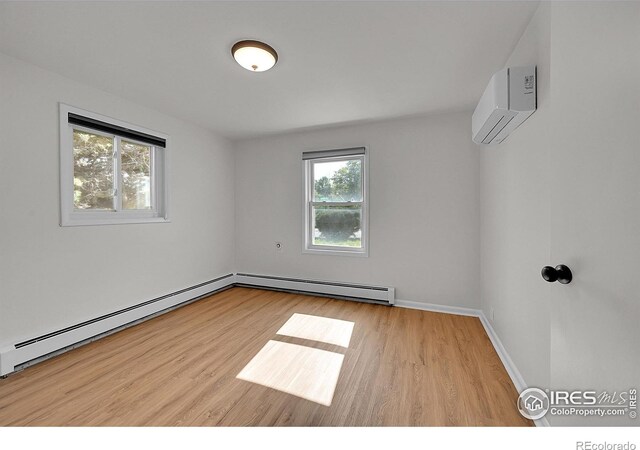 707 E Emma St, Lafayette, CO 80026 - unfurnished room featuring baseboard heating, a wall mounted AC, and wood finished floors