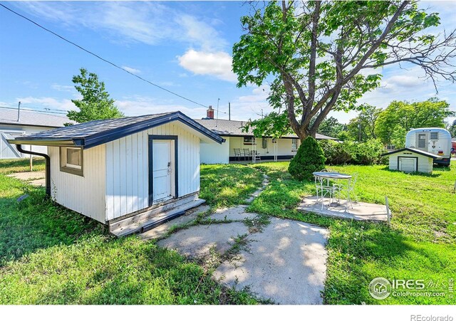 707 E Emma St, Lafayette, CO 80026 - view of green lawn featuring a storage shed and a patio