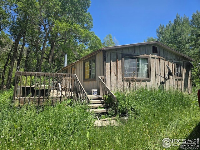 20881 Buckhorn Rd, Bellvue, CO 80512 - view of side of home with board and batten siding and a deck