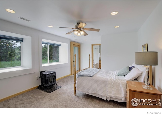 849 Mountain Meadows Rd, Boulder, CO 80302 - carpeted bedroom with recessed lighting, a wood stove, and a ceiling fan