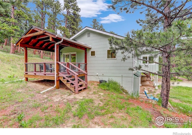 849 Mountain Meadows Rd, Boulder, CO 80302 - back of property with a wooden deck