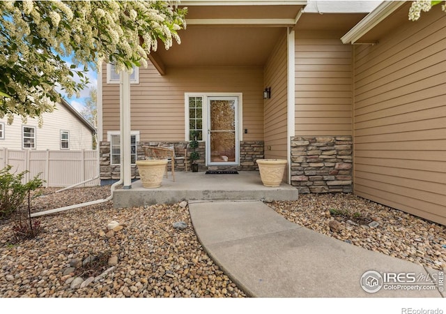 5452 Rustic Ave, Firestone, CO 80504 - entrance to property featuring stone siding and a patio area