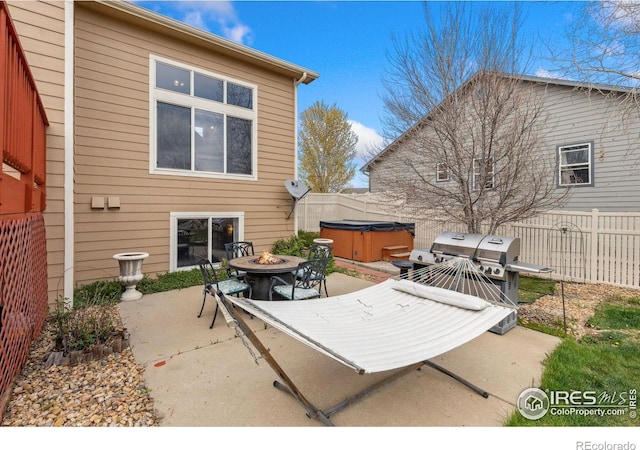 5452 Rustic Ave, Firestone, CO 80504 - view of patio / terrace with a hot tub, an outdoor fire pit, and a grill