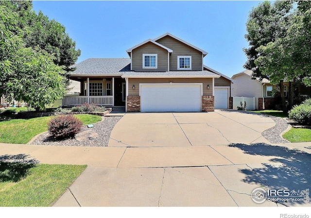 3228 Borrossa St, Evans, CO 80634 - view of front of home with brick siding, covered porch, concrete driveway, and a garage