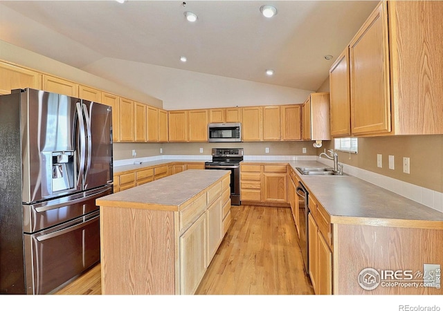 3228 Borrossa St, Evans, CO 80634 - kitchen featuring stainless steel appliances, light brown cabinets, lofted ceiling, a center island, and light wood finished floors