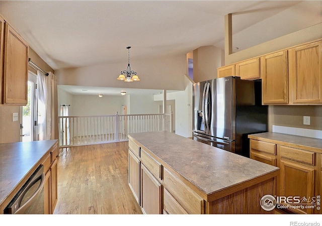 3228 Borrossa St, Evans, CO 80634 - kitchen with stainless steel appliances, lofted ceiling, light wood-type flooring, pendant lighting, and a center island
