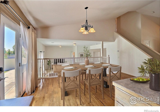 3228 Borrossa St, Evans, CO 80634 - dining space with vaulted ceiling, light wood-style floors, and a chandelier