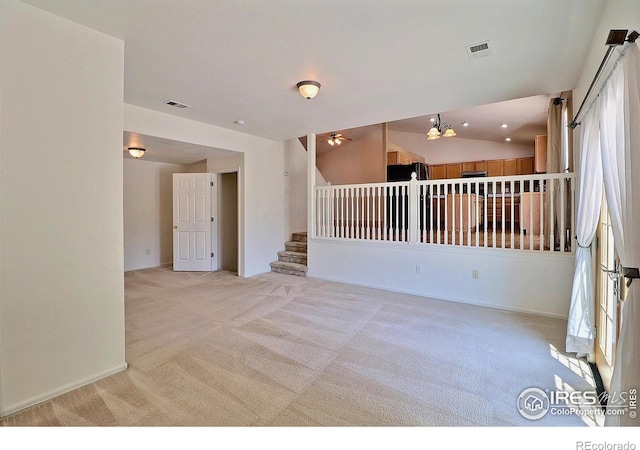 3228 Borrossa St, Evans, CO 80634 - empty room featuring light carpet, stairway, and lofted ceiling