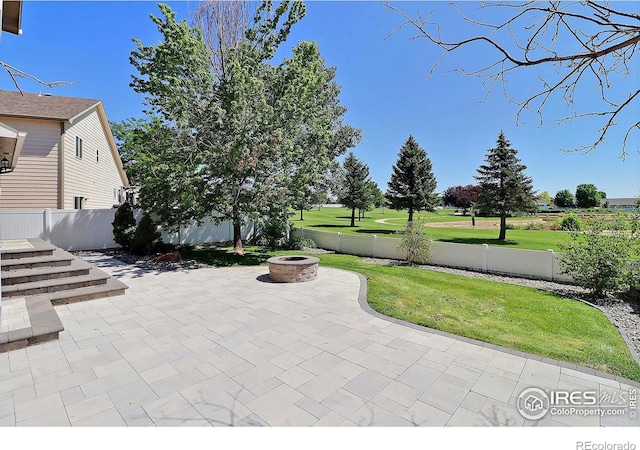 3228 Borrossa St, Evans, CO 80634 - fenced backyard with a fire pit and a patio area