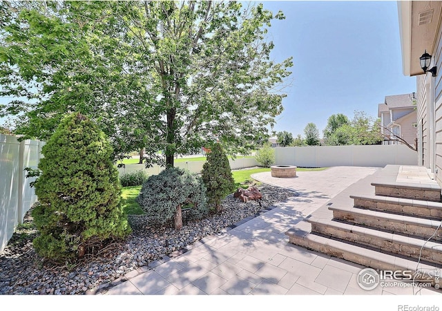 3228 Borrossa St, Evans, CO 80634 - fenced backyard featuring an outdoor fire pit and a patio area