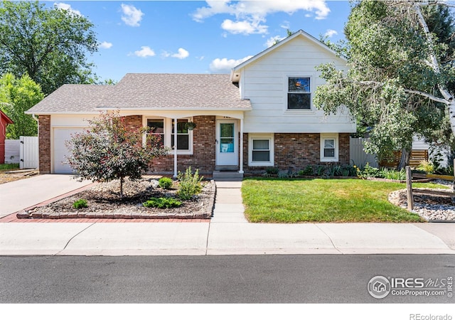 109 Sunflower Dr, Windsor, CO 80550 - view of front facade with brick siding, concrete driveway, a front yard, an attached garage, and a shingled roof