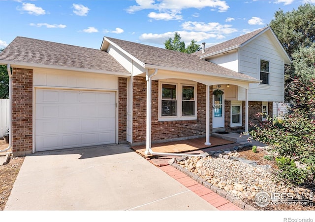 109 Sunflower Dr, Windsor, CO 80550 - tri-level home with a garage, brick siding, driveway, and roof with shingles