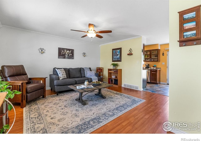 109 Sunflower Dr, Windsor, CO 80550 - living room featuring wood finished floors, a ceiling fan, and ornamental molding