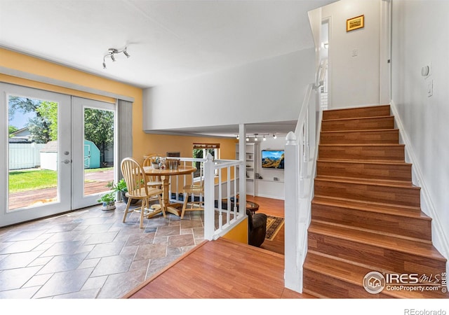 109 Sunflower Dr, Windsor, CO 80550 - dining room with french doors, stairs, rail lighting, and stone finish flooring