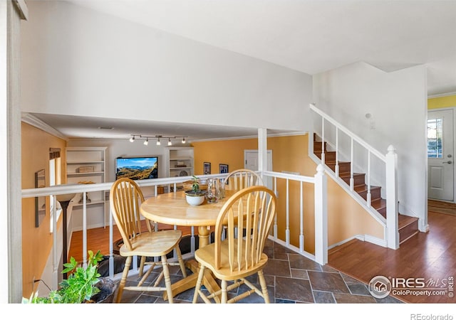 109 Sunflower Dr, Windsor, CO 80550 - dining area with ornamental molding, stairs, and stone finish floors