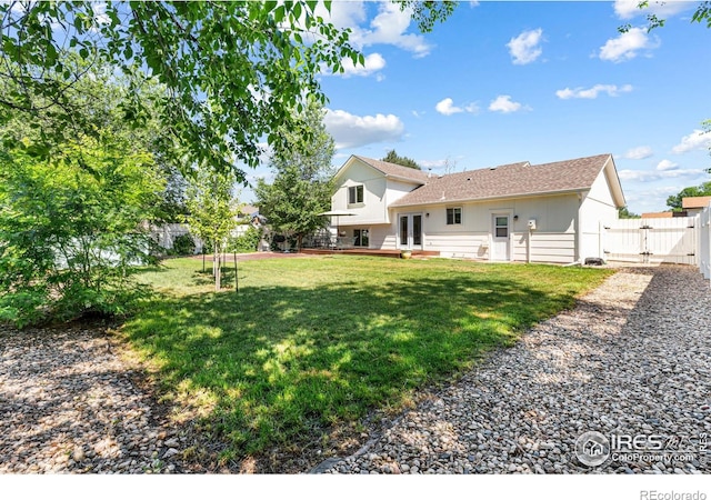 109 Sunflower Dr, Windsor, CO 80550 - back of house featuring a gate, french doors, a fenced backyard, roof with shingles, and a deck