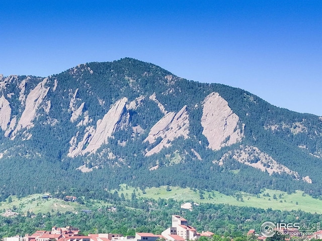 3601 Arapahoe Ave Unit 304, Boulder, CO 80303 - view of mountain backdrop featuring a heavily wooded area