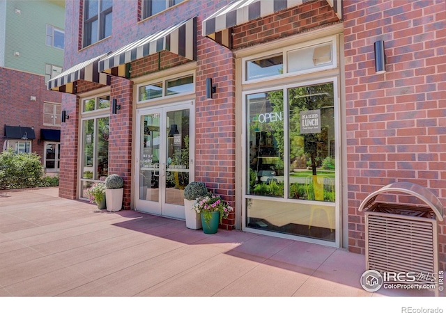 3601 Arapahoe Ave Unit 304, Boulder, CO 80303 - doorway to property featuring brick siding and french doors