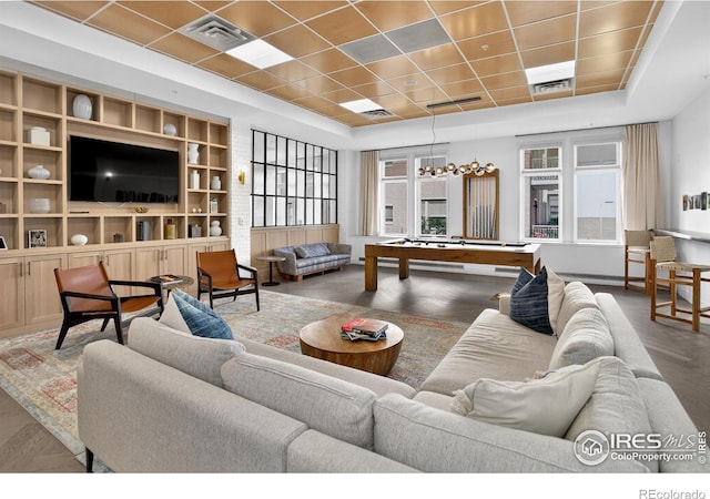 3601 Arapahoe Ave Unit 304, Boulder, CO 80303 - living room with wood finished floors, built in features, a chandelier, and a drop ceiling
