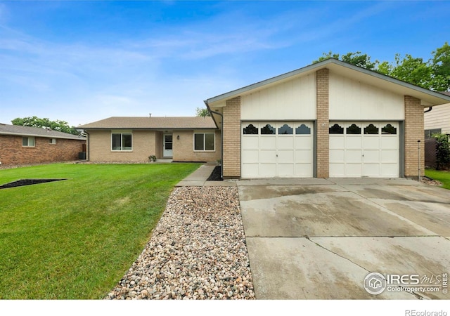 3107 White Elm Ct, Loveland, CO 80538 - ranch-style home featuring a garage, concrete driveway, a front lawn, and brick siding