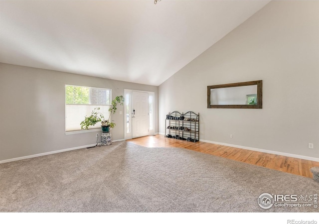 232 Ricker Ln, Johnstown, CO 80534 - carpeted entryway with lofted ceiling and wood finished floors