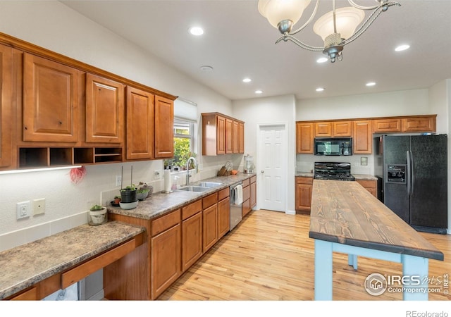 232 Ricker Ln, Johnstown, CO 80534 - kitchen with black appliances, light wood finished floors, recessed lighting, butcher block counters, and brown cabinets