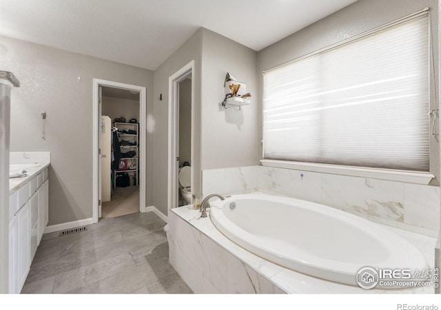 232 Ricker Ln, Johnstown, CO 80534 - bathroom with a bath, a walk in closet, and vanity
