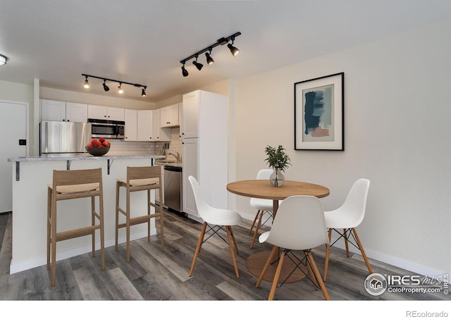 1121 Albion St # 402, Denver, CO 80220 - dining room with dark wood-style floors and rail lighting