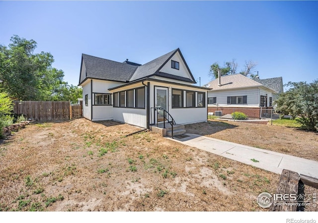 311 12th Ave, Greeley, CO 80631 - view of front of house featuring a sunroom and a shingled roof