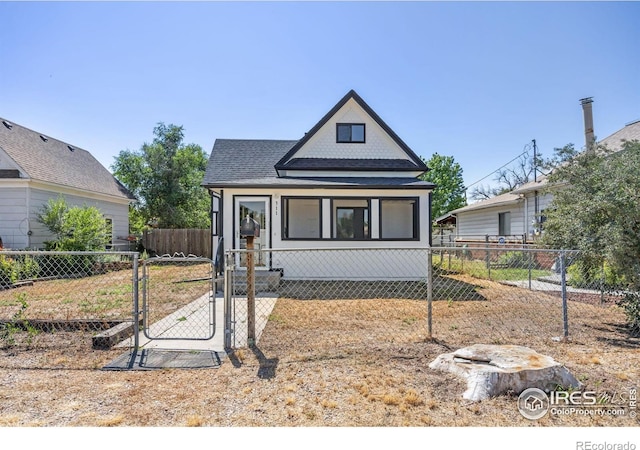 311 12th Ave, Greeley, CO 80631 - view of front of property with a gate, a fenced front yard, and a shingled roof