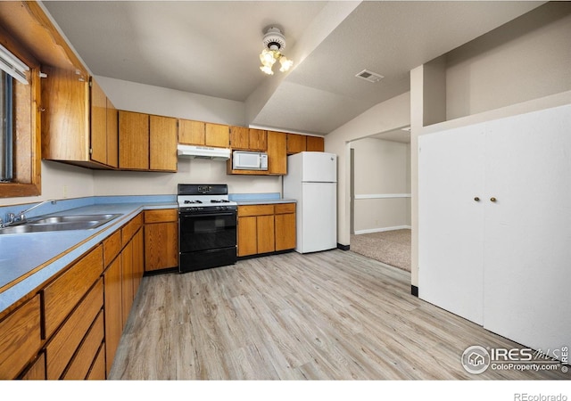 311 12th Ave, Greeley, CO 80631 - kitchen with white appliances, under cabinet range hood, brown cabinetry, light wood-style flooring, and light countertops