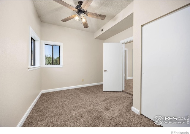 311 12th Ave, Greeley, CO 80631 - unfurnished bedroom with carpet flooring, a textured ceiling, and a ceiling fan