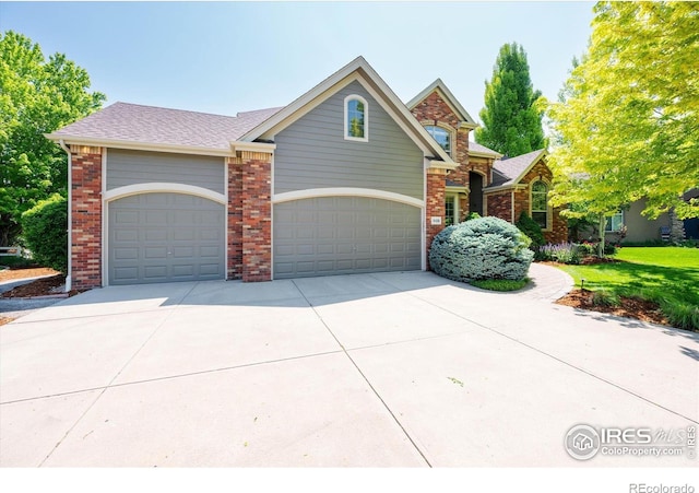 8416 Starfish Ct, Windsor, CO 80528 - traditional-style house featuring concrete driveway, brick siding, an attached garage, and a shingled roof