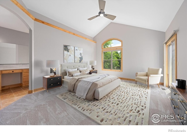 8416 Starfish Ct, Windsor, CO 80528 - carpeted bedroom featuring vaulted ceiling, arched walkways, ensuite bath, tile patterned flooring, and ceiling fan