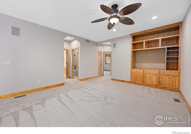 8416 Starfish Ct, Windsor, CO 80528 - unfurnished living room with arched walkways, ceiling fan, light carpet, and recessed lighting