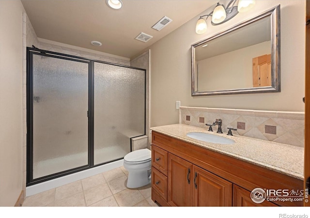 8416 Starfish Ct, Windsor, CO 80528 - bathroom featuring vanity, a shower stall, tasteful backsplash, and tile patterned floors