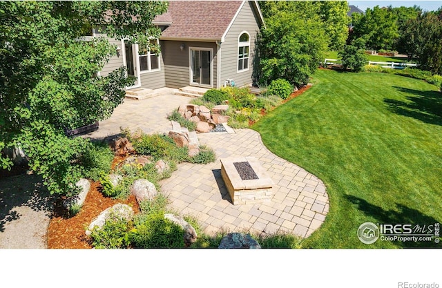 8416 Starfish Ct, Windsor, CO 80528 - view of green lawn with a patio and an outdoor fire pit