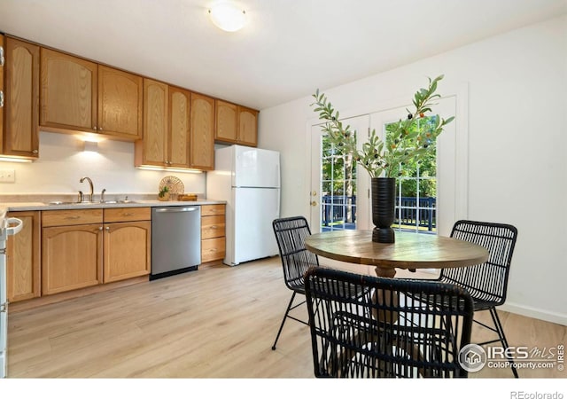 930 Vanderbilt Ct, Fort Collins, CO 80525 - kitchen with dishwasher, freestanding refrigerator, light wood-style floors, and light countertops